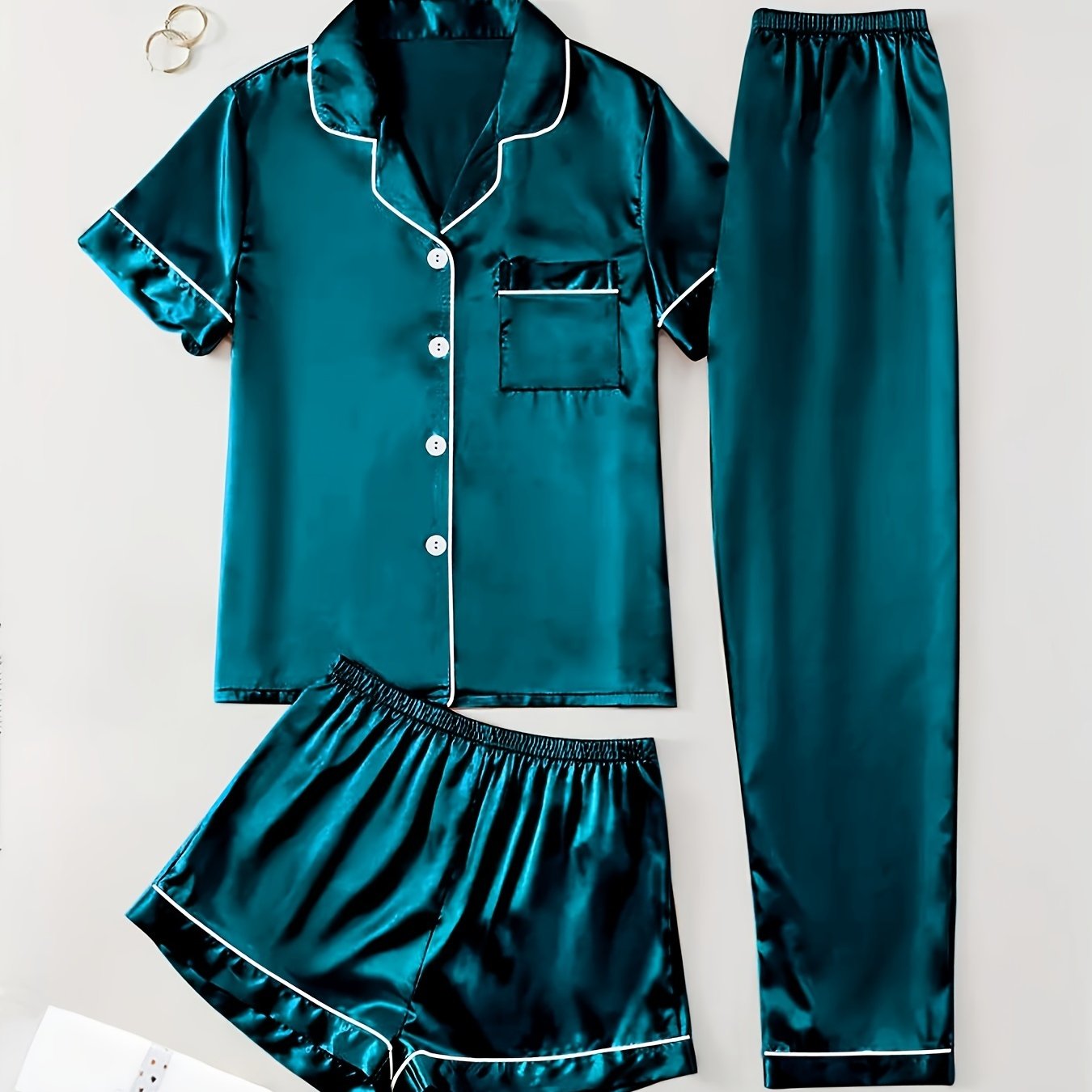 3-piece summer satin pajama set for women featuring collared shirt, long pants, and shorts. Made of 95% polyester and 5% elastane. Available in sizes S-XL.