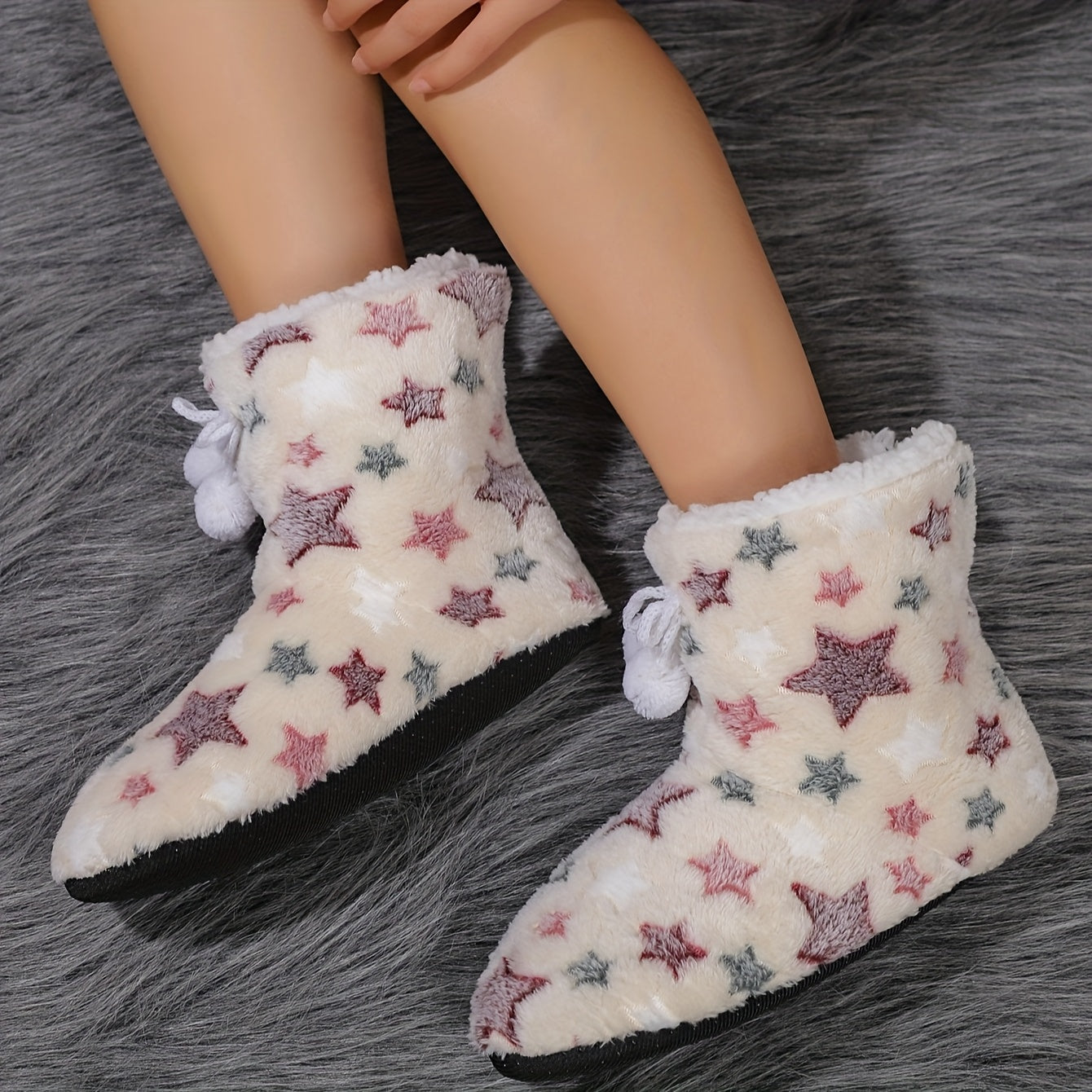 Heart-patterned slipper boots with cozy fleece lining, machine washable for indoor wear.