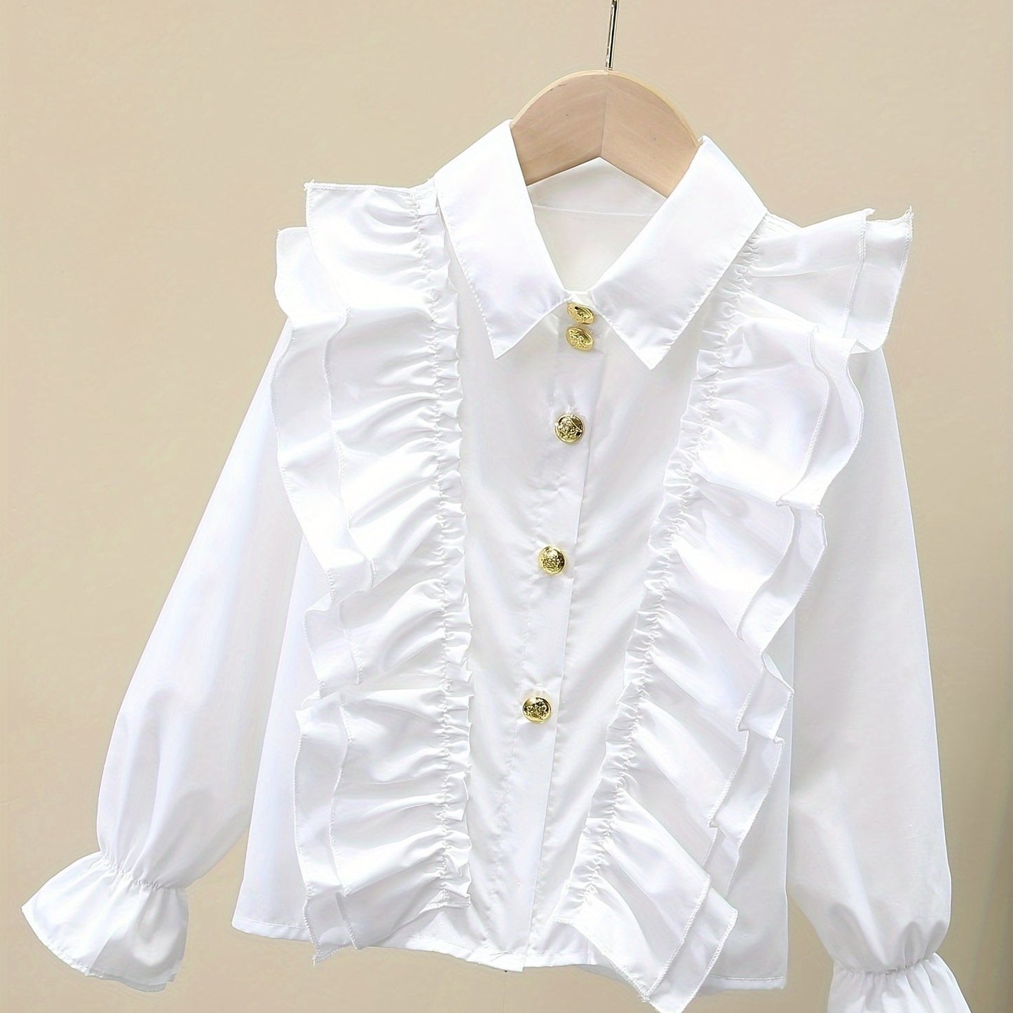 Stylish girls' long-sleeve dress shirt with ruffled cuffs and metal buttons - perfect for school uniforms or fashionable looks.