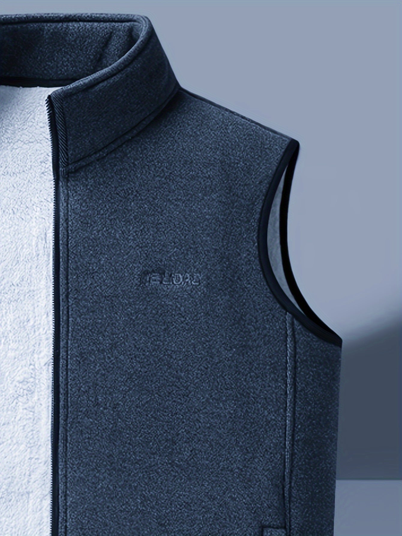 Men's cozy fleece-lined vest with stand collar, zipper pockets, and button closure for fall/winter warmth.