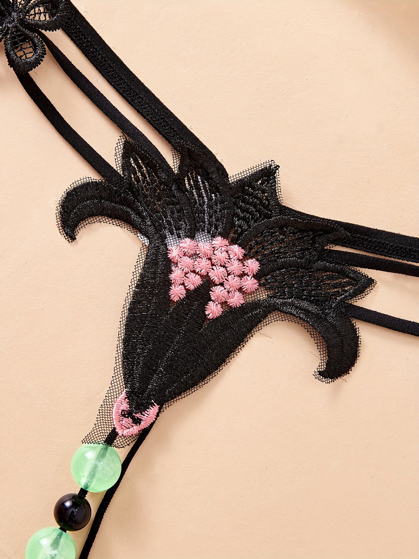 Large luminous beaded massage thong for women - perfect for nights out.