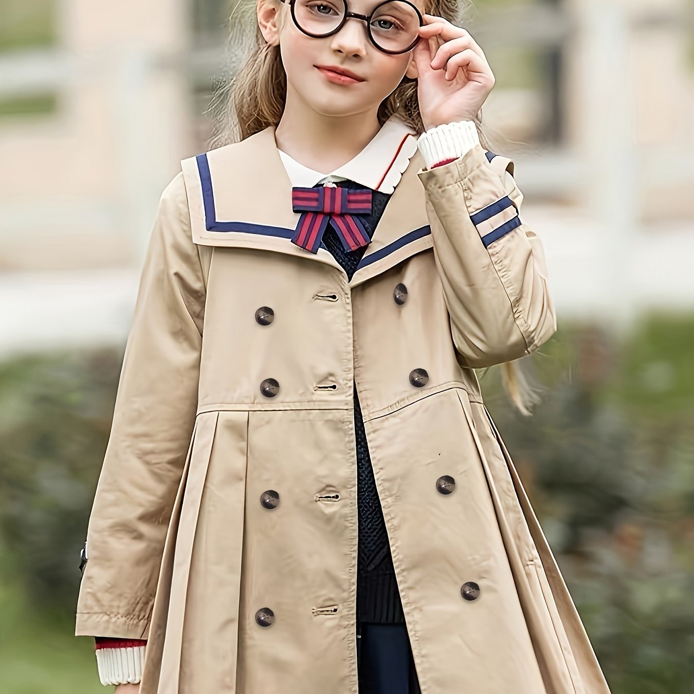 Girls' lightweight British-inspired school uniform trench coat and pleated skirt set. Windproof polyester material with front buttons. Ideal for spring and autumn. Available in sizes 4-12.