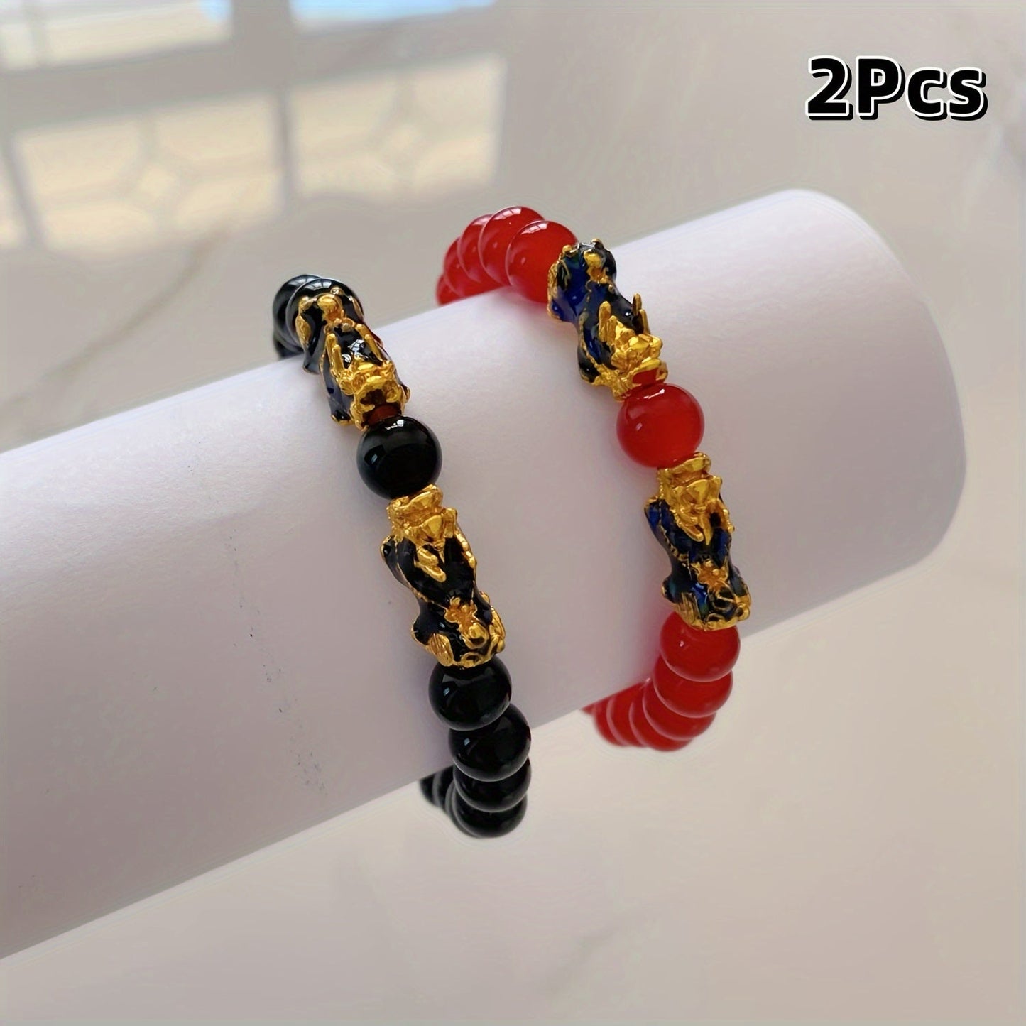 Two Pixiu bracelets, one in red antique style, offering a safe and lucky accessory. This classic, luxurious piece symbolizes prosperity and is beautifully crafted with shiny, artificial jewels. Perfect for gifting to girlfriends, sisters, or mothers to