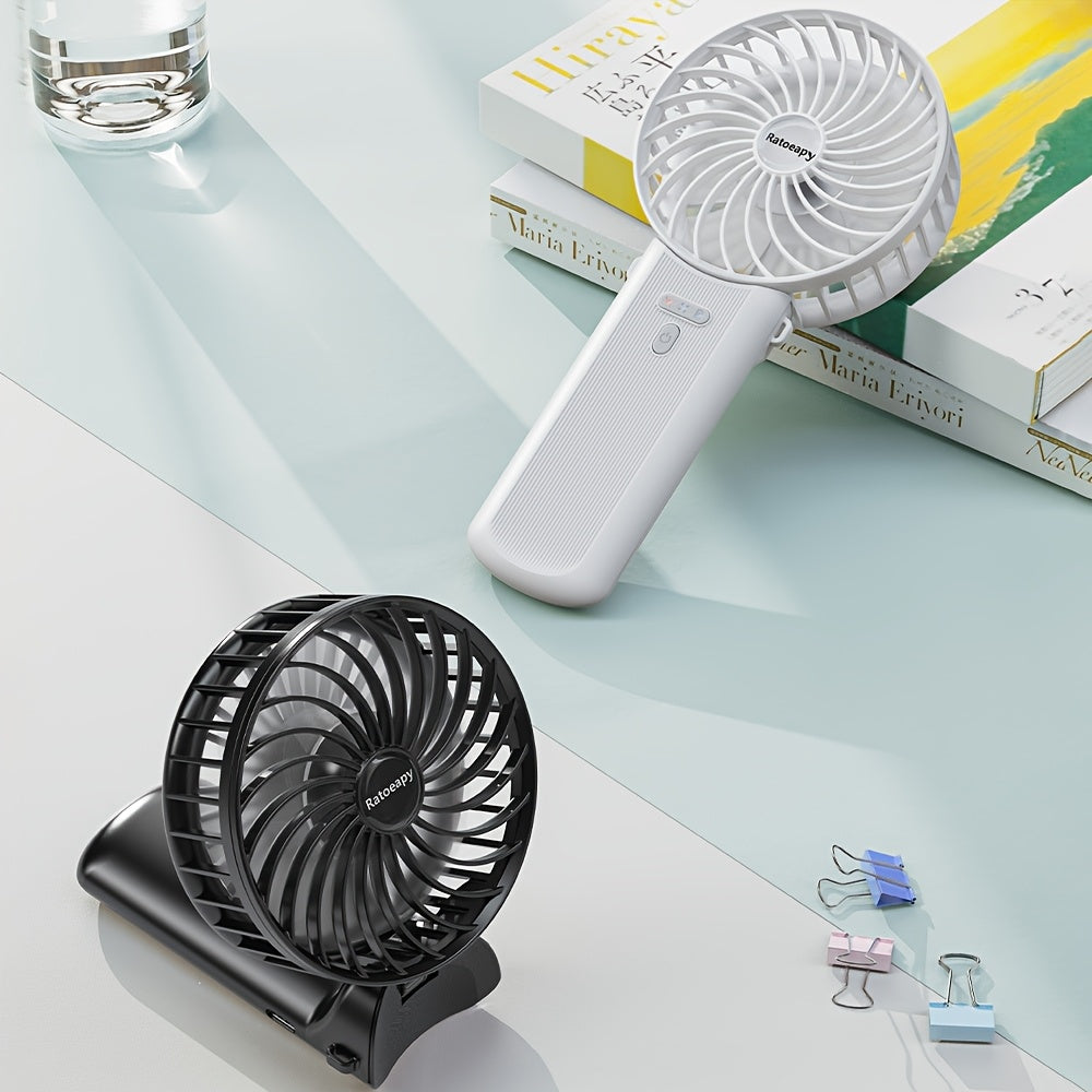 Handheld Fan with 180° Foldable Stand and Wearable Neck Strap, USB Rechargeable, 7-Blade Design, 4-Speed Adjustable, High-Velocity Cooling, 2000mAh Lithium Battery, Button Controls, Sleek Plastic Finish for Indoor and Outdoor Use.