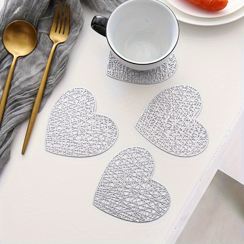 Set of 4 heart-shaped placemats and coasters made of PVC with heat insulation and non-slip features, ideal for household decoration and meal protection on dining tables.