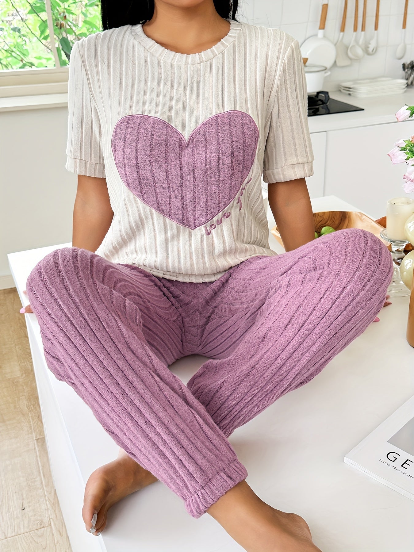 Women's heart and letter print pajama set with short sleeve top and joggers, relaxed fit for comfortable summer nightwear.