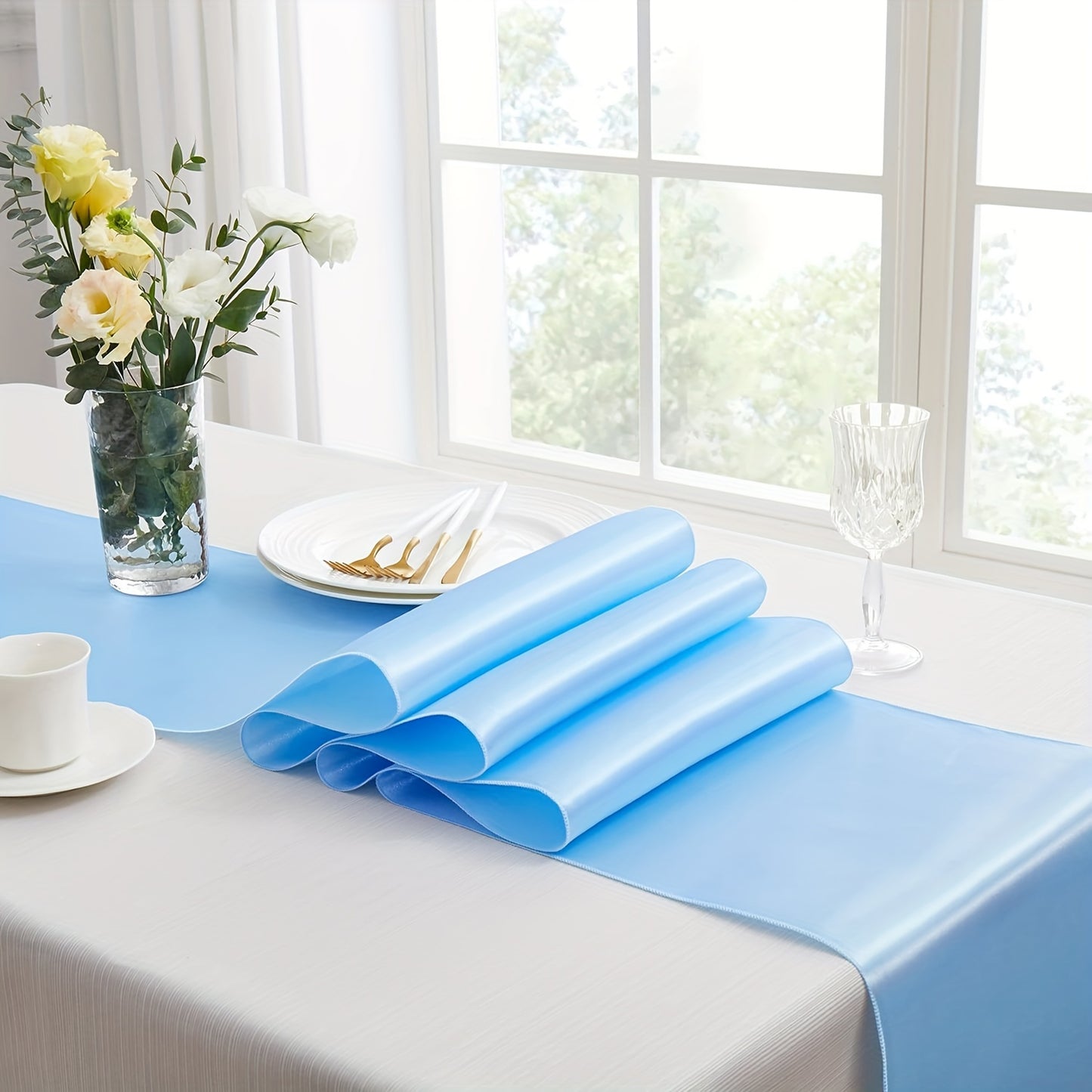 Elegant light blue satin table runner, 30.48 x 274.32 cm, ideal for weddings and formal events.