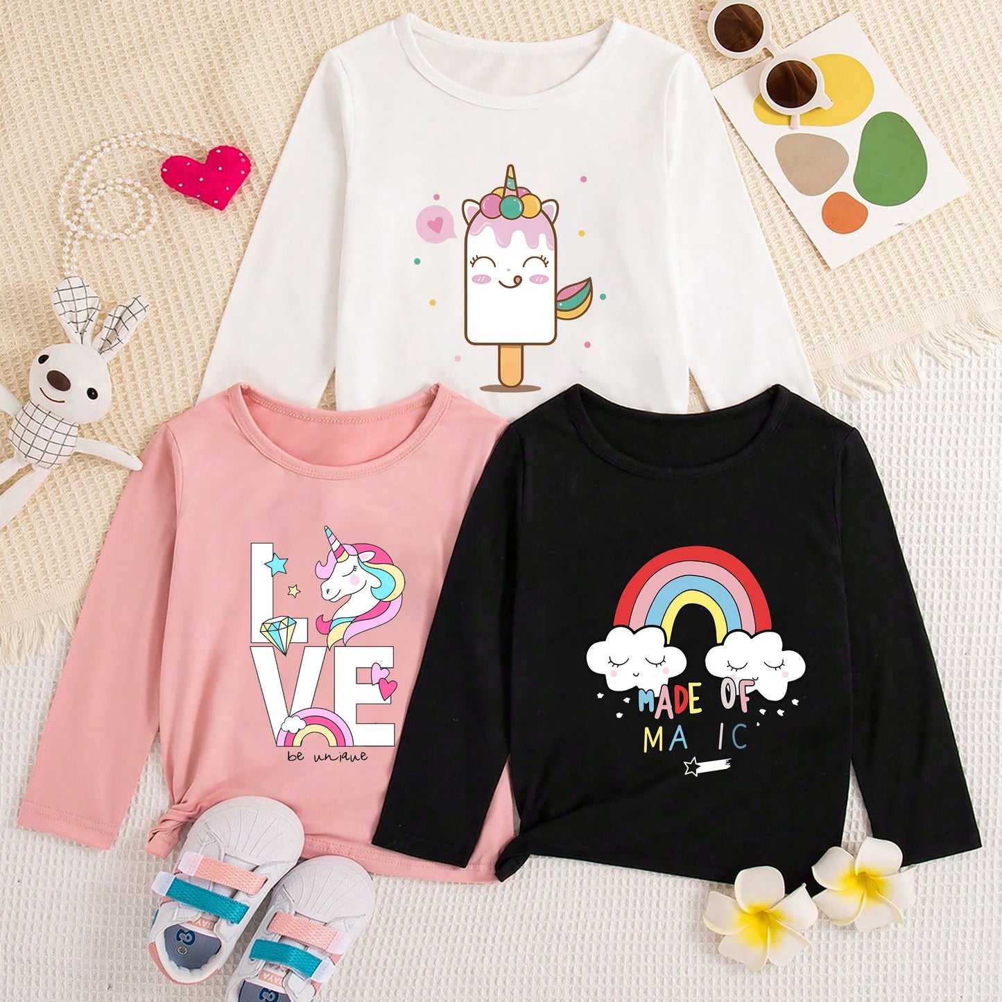 3 adorable unicorn print girls' long-sleeve crew neck t-shirts in polyester, perfect for spring and fall. Regular fit with a knit fabric.