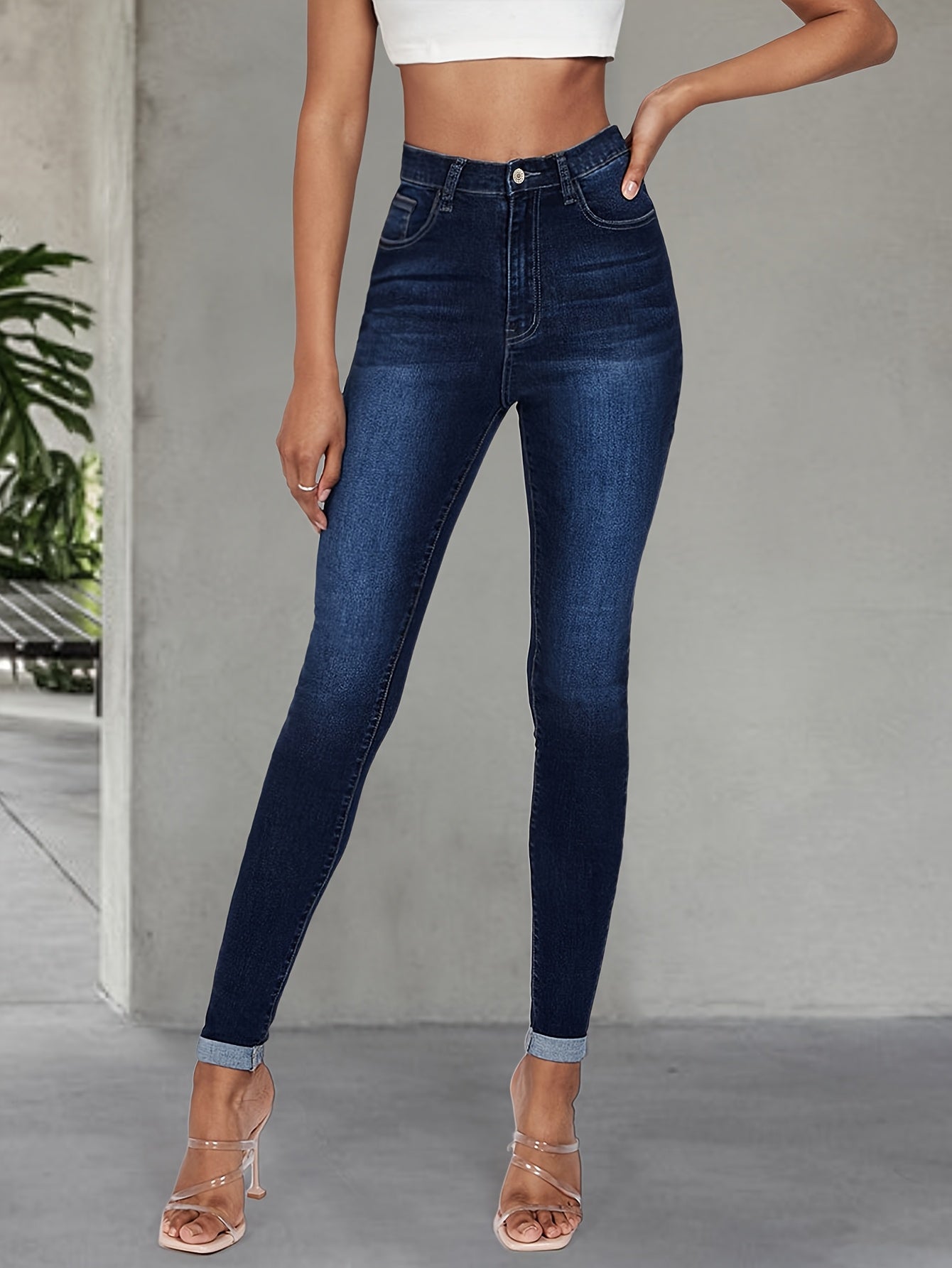 Elegant high stretch skinny jeans for women, long length with button detail, perfect for all seasons.