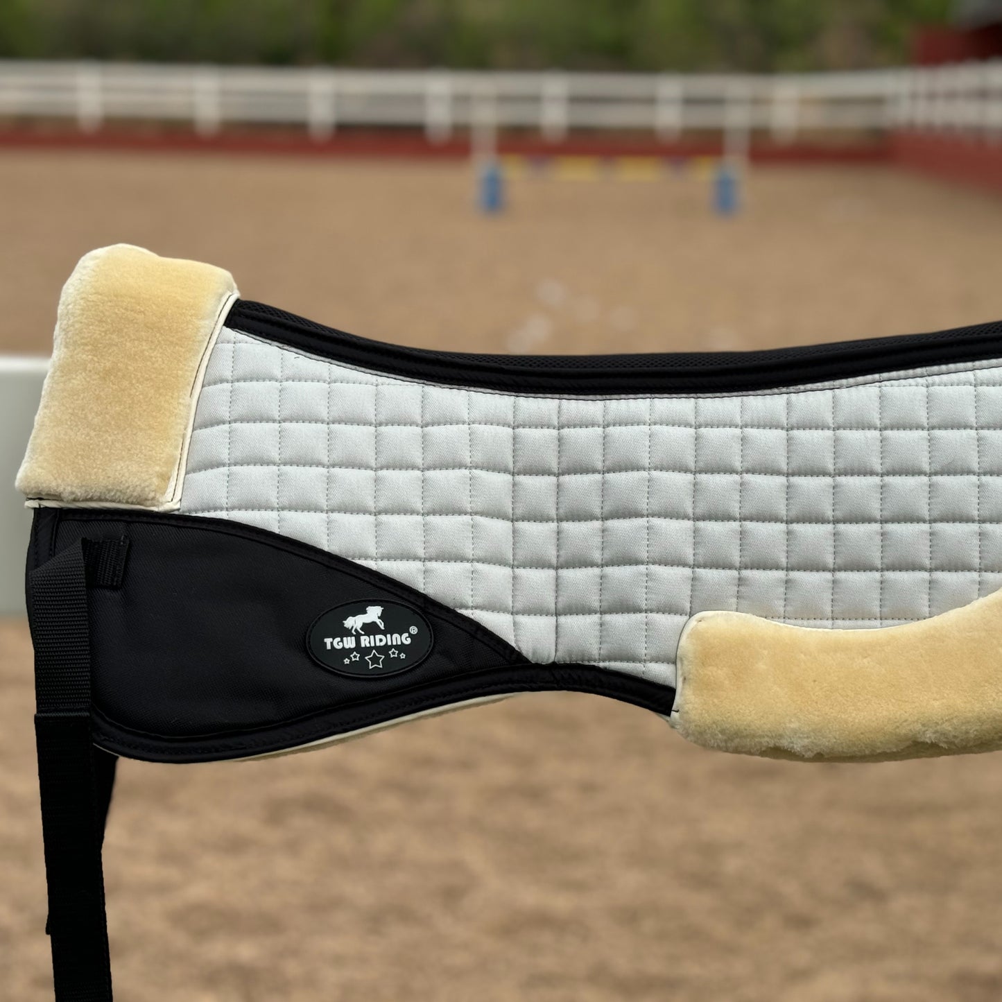 English saddle horse half pad with 100% woven fabric outer and shape-retaining foam insert, featuring a thick, soft, non-shedding synthetic sheepskin for easy cleaning.