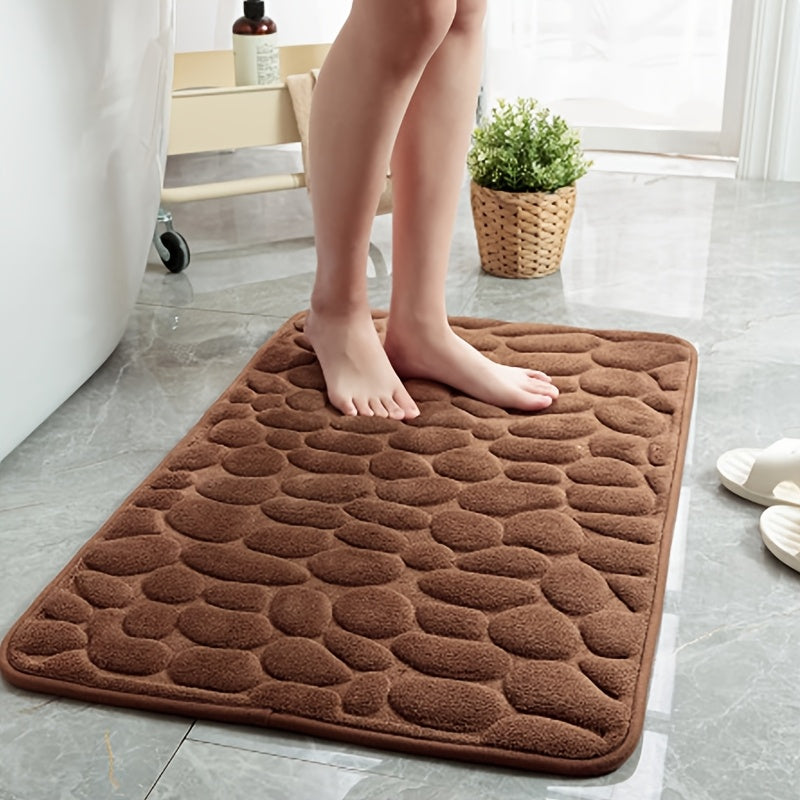 The Coral Fleece Non-Slip Bath Mat features a pebble design and is made of memory foam for ultimate comfort. This machine-washable bathroom rug has a solid pattern, flat woven construction, and low pile for easy care. It has a weight of 400gsm and comes