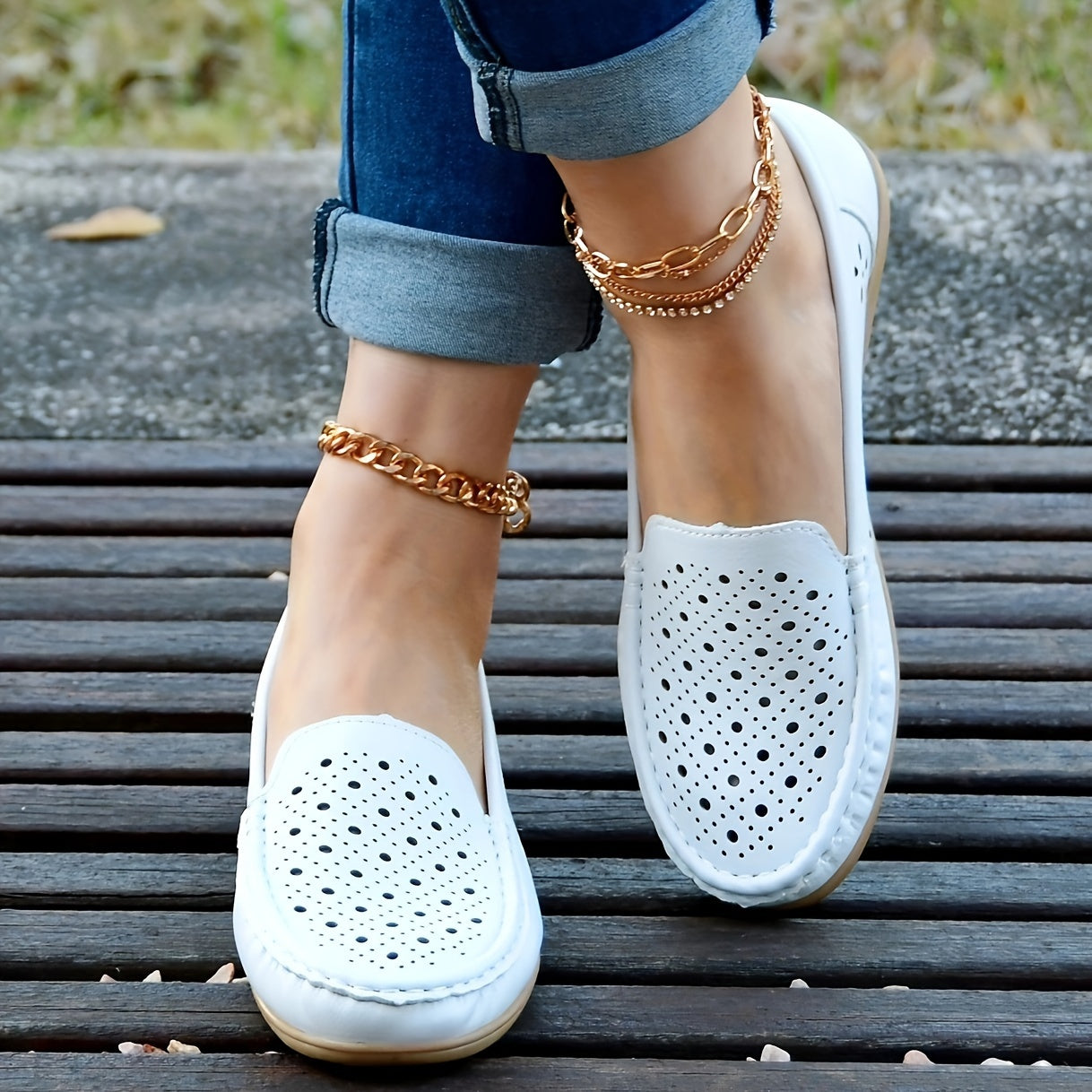 Women's white slip-on loafers with perforated design for breathability, non-slip sole, round toe, and versatile casual style for all-season wear.