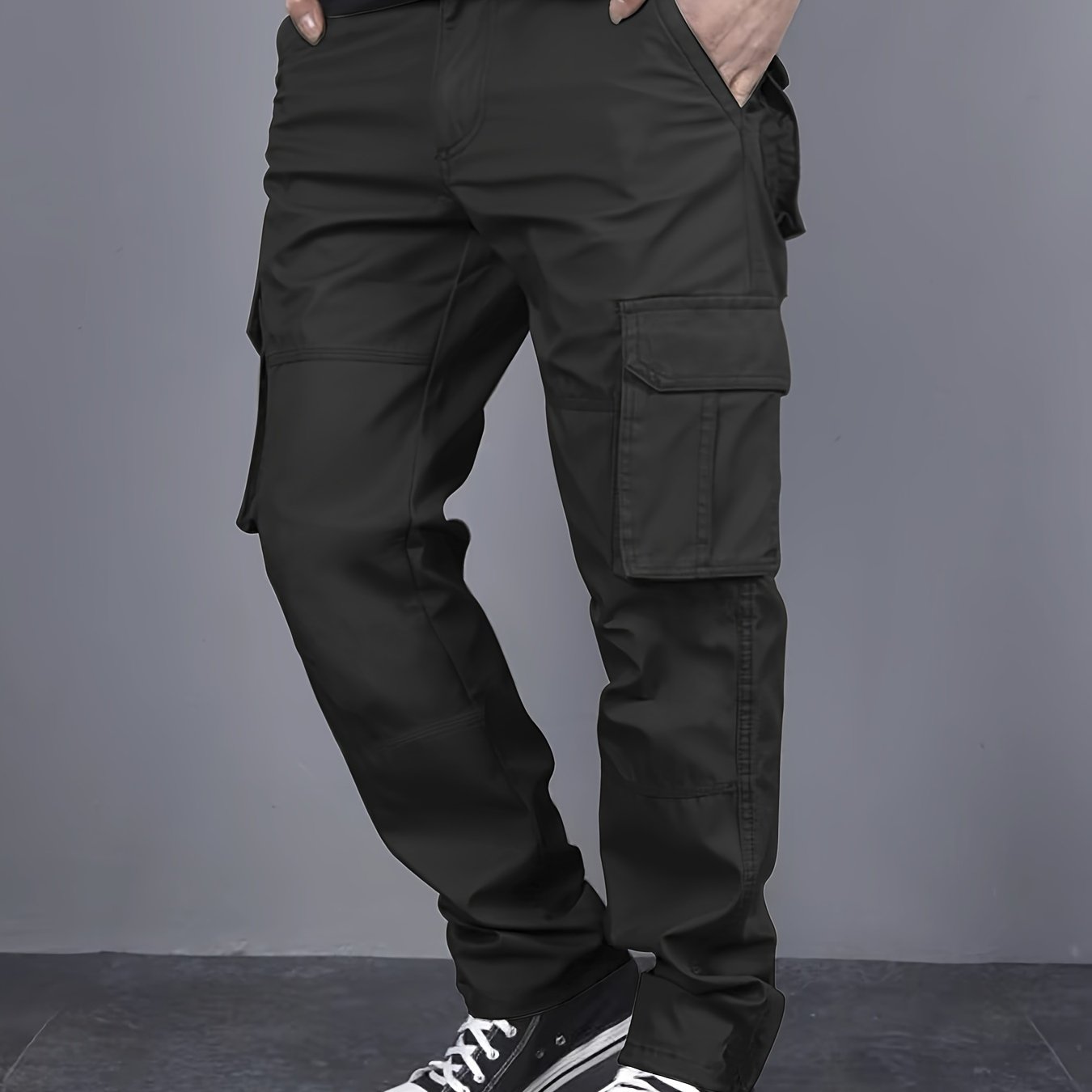 Solid color cargo pants with multiple flap pockets and a drawstring waistband, perfect for outdoor activities like hiking, fishing, and camping.