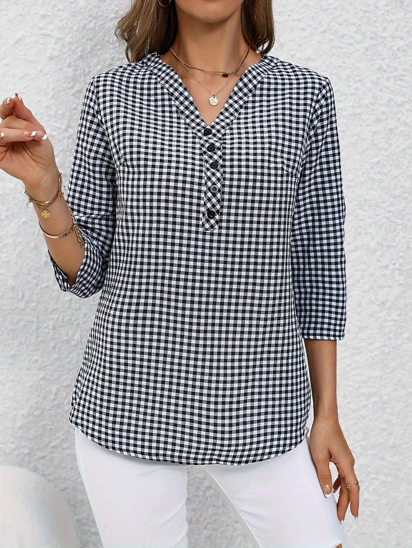 Women's yellow & white plaid button-up shirt with v-neck, long sleeves, and polyester fabric. Casual wear.