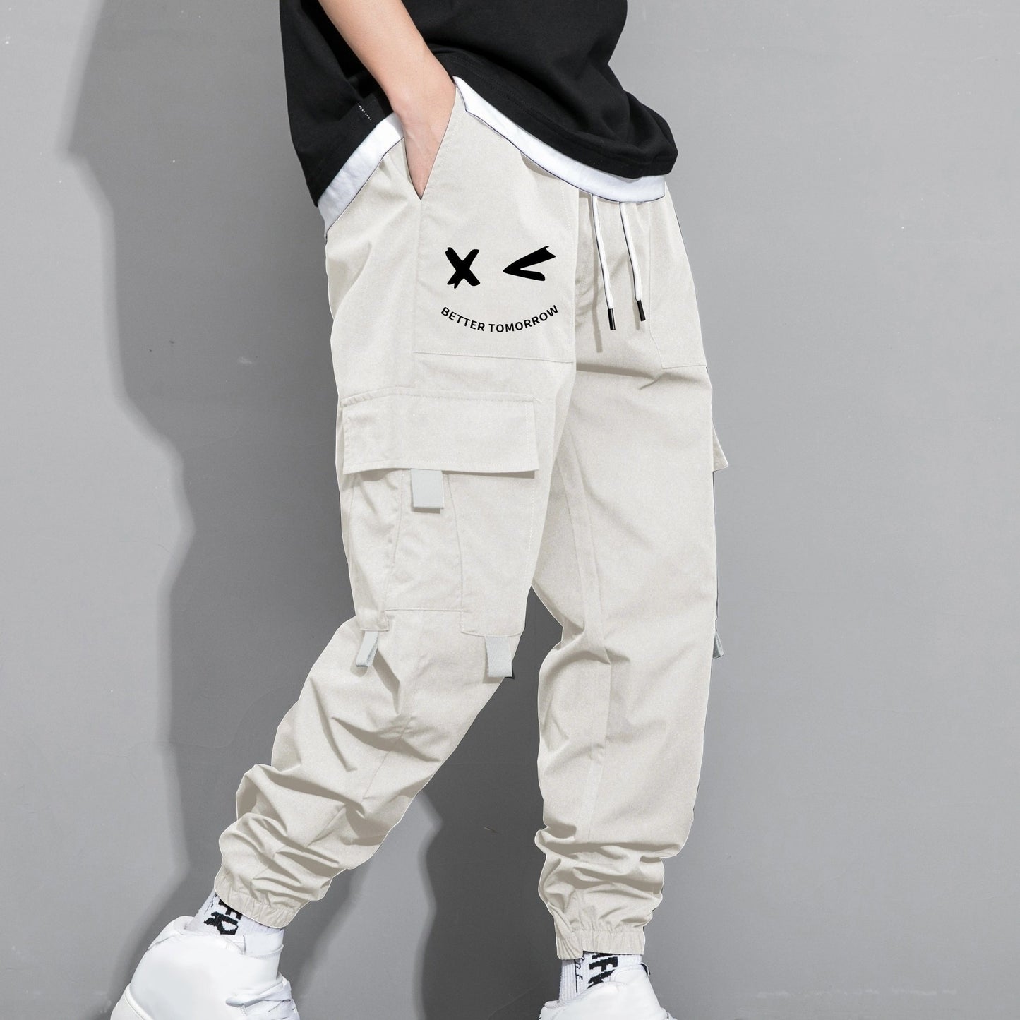 Stylish cargo pants with multiple pockets for men, featuring a loose fit and drawstring waistband for a casual outdoor streetwear look.