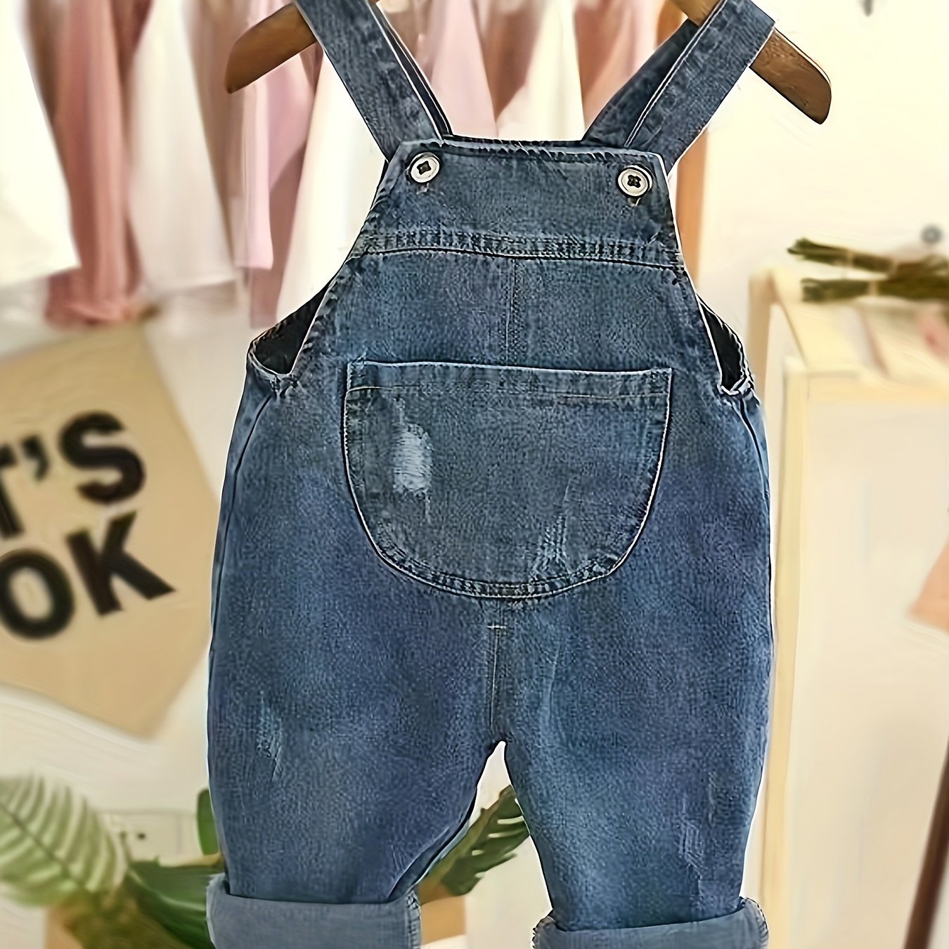 Infant & toddler girl's denim jumpsuit with pocket patches and ripped overalls, perfect for spring and summer.