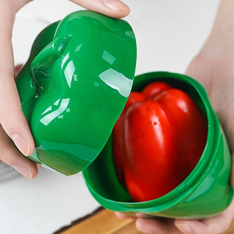 Food storage container in the shape of a green pepper, made of reusable and hand-washable plastic with a flip-top lid. Perfect for storing fresh veggies and other items in the kitchen. Can be used as a multifunctional organizer on the countertop.