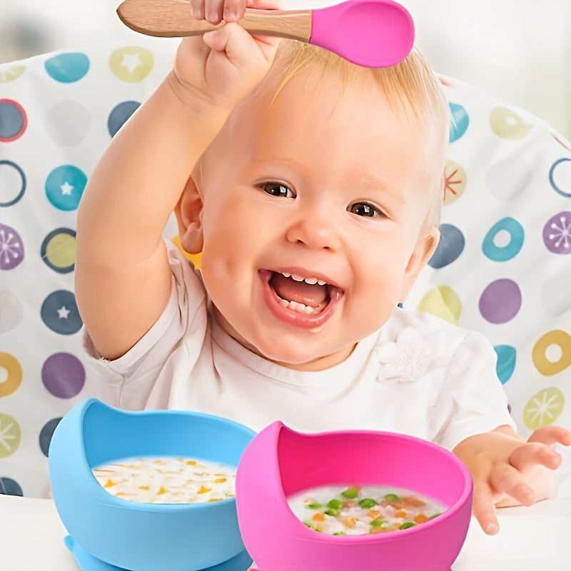 Three pieces of silicone feeding bowl, fork, and spoon set with durable suction bowl. Includes feeding kit with wooden handle, non-slip design, and microwave safe.