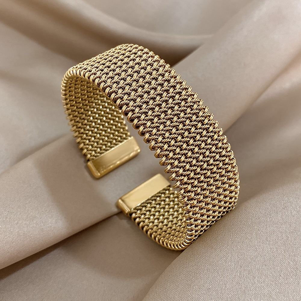 Stylish woven stainless steel bracelet with a golden touch, versatile accessory in trendy golden tone.