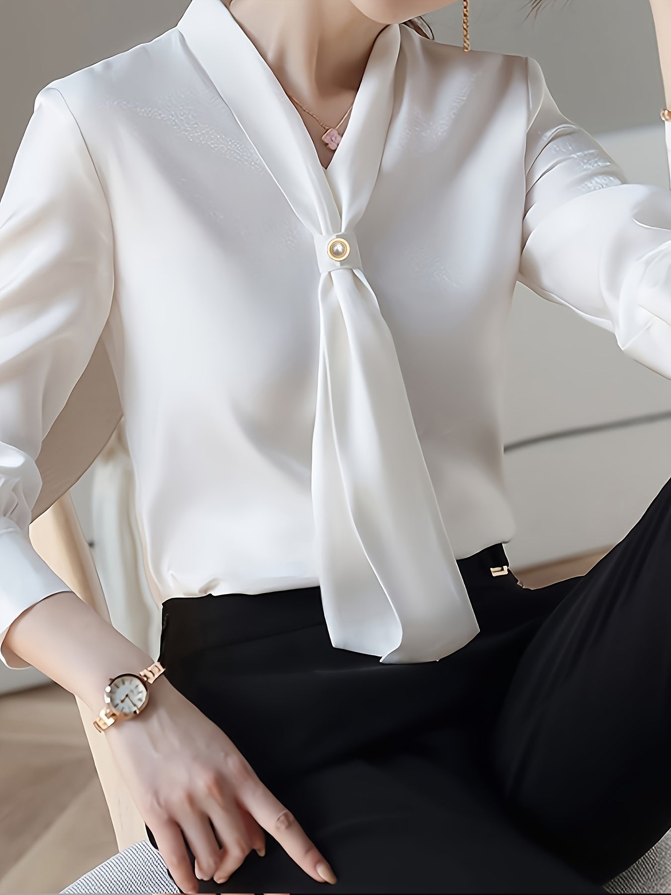 Stylish V-neck shirt with bow tie decoration for women, made of 100% polyester. Regular fit with single breasted placket. Woven fabric, suitable for all seasons.