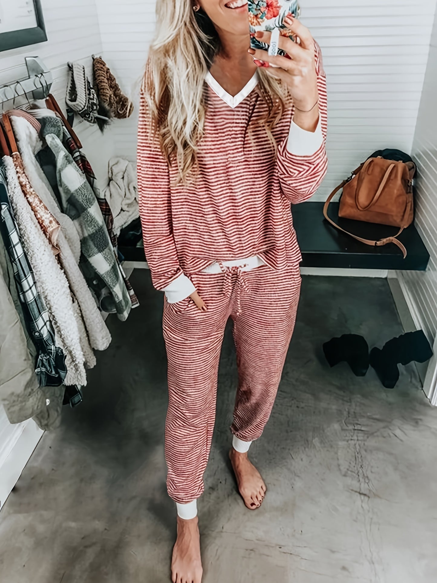 Casual knit pajama set with V-neck, striped design, and drawstring. Made of 95% polyester and 5% elastane for fall/winter home wear. Includes long sleeve top and matching lounge pants.