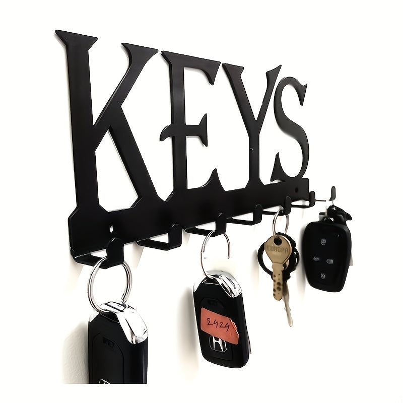 Black metal key holder with decorative hooks for organizing coats, hats, and more. Wall-mounted storage rack for home and hallway. Rust-proof design.