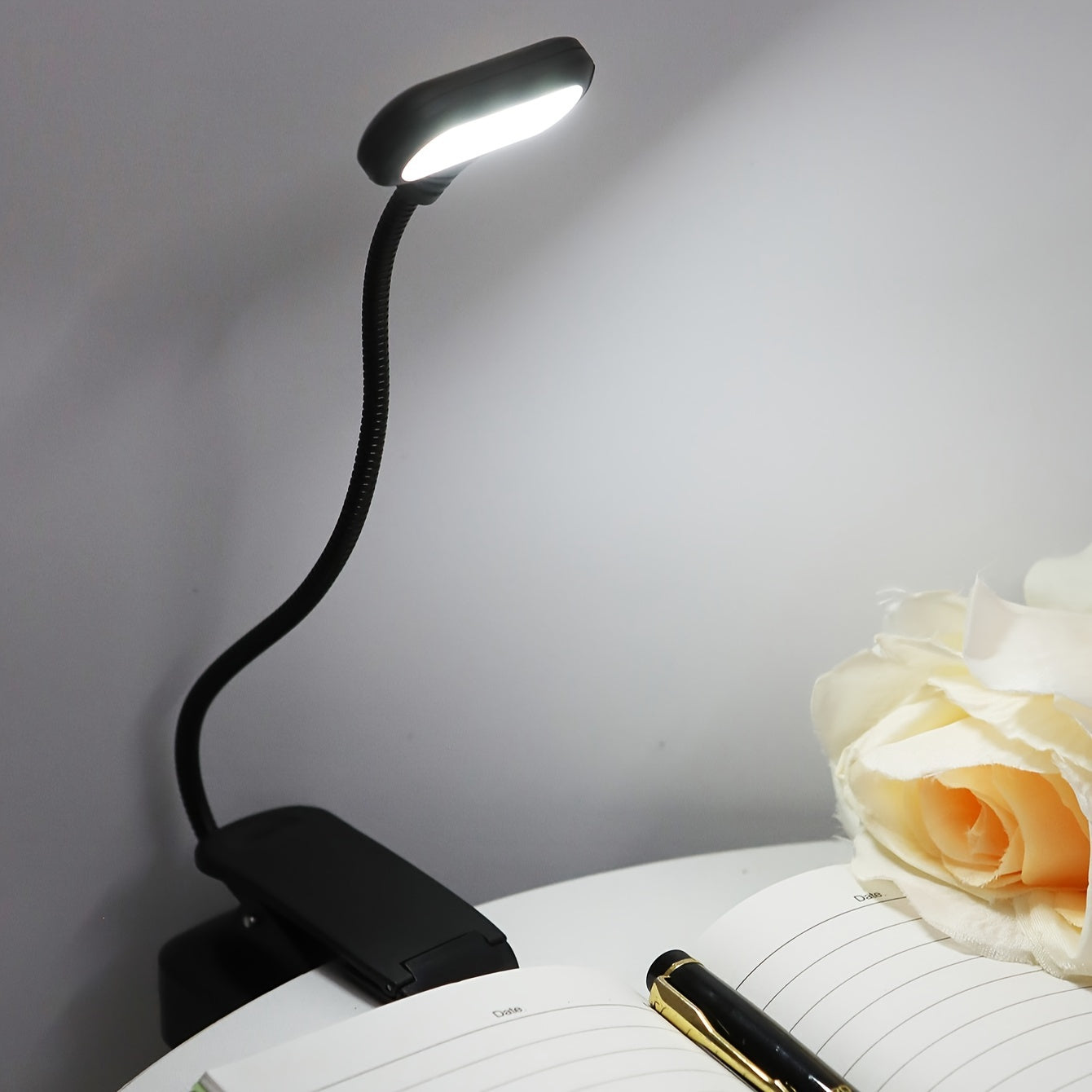 Portable LED book light with adjustable arm, push button control, and polished finish. Battery not included.