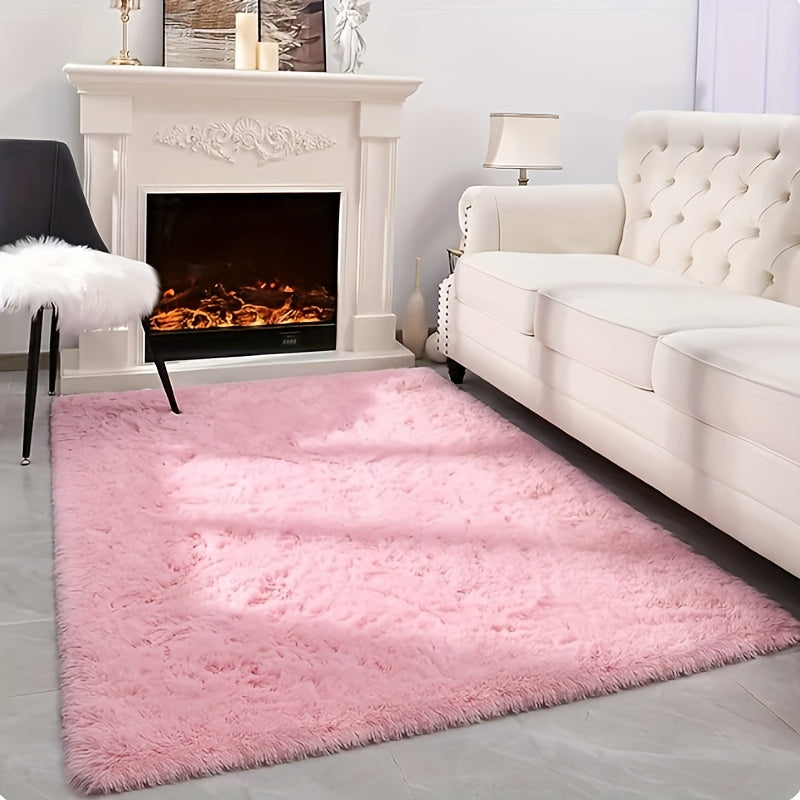 This solid pink polyester area rug is both fluffy and durable, making it perfect for any room in your home or office. The non-slip backing ensures safety, while the stain-resistant material is easy to clean with dry cleaning. This machine-made