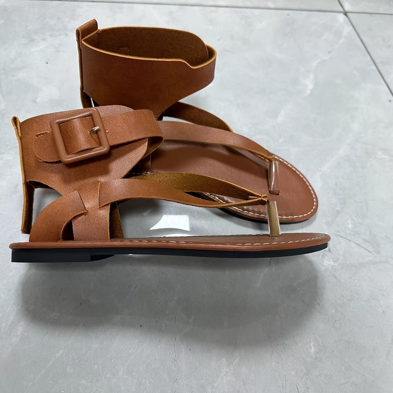 Chic black flat sandals with ankle strap, faux leather upper, and EVA sole, perfect for all-season wear.