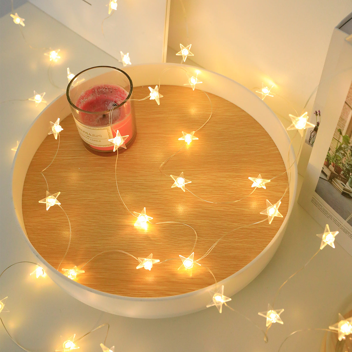 Star-shaped LED fairy lights in modern copper wire designs are available in 1m, 2m, and 3m lengths with 10, 20, and 30 LEDs respectively. Designed for universal holiday decor, these lights are battery operated and do not contain feathers.