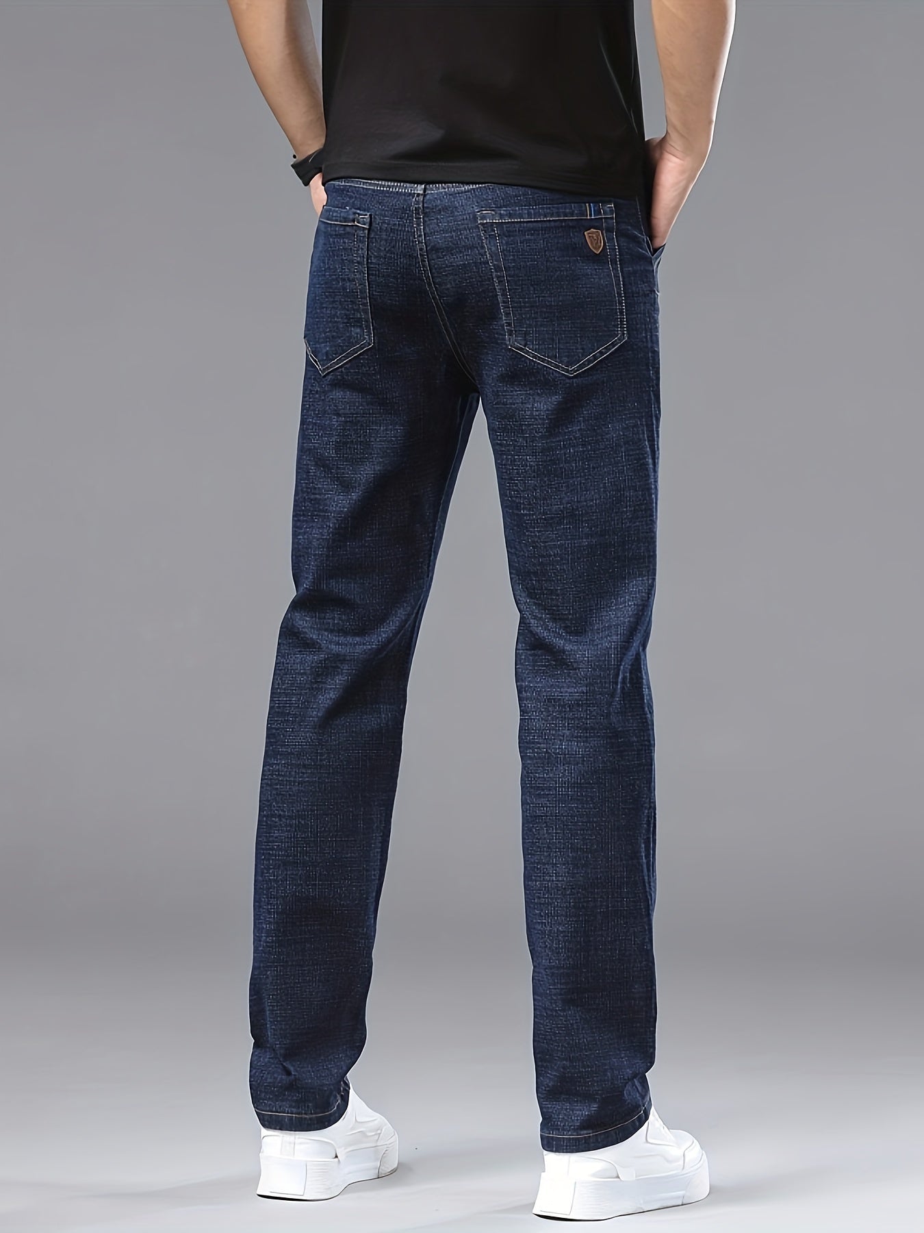 Men's slim-fit jeans made of 61.6% cotton, 36.9% polyester, and 1.5% spandex with all-season stretch denim. Raw wash in a solid color, regular fit for casual weekends. 200gsm woven fabric.