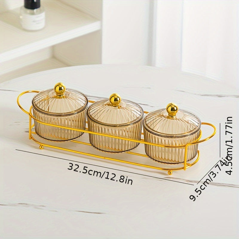 Luxurious snack serving set with lid-covered plastic dishes on a golden tray, perfect for displaying dried fruits and candies on a living room coffee table.