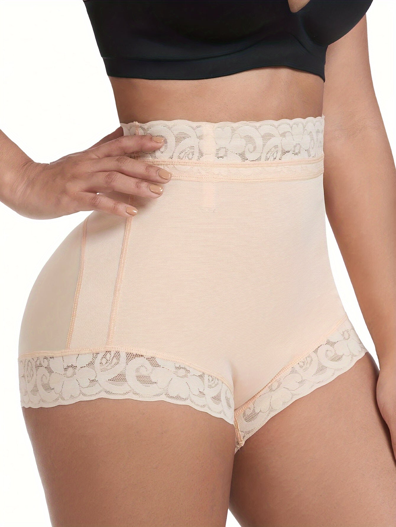 High-waisted shaping shorts for women with tummy control and butt lifting features. Made of stretch nylon with floral lace trim, in beige color. Hand wash only. Cute panties.