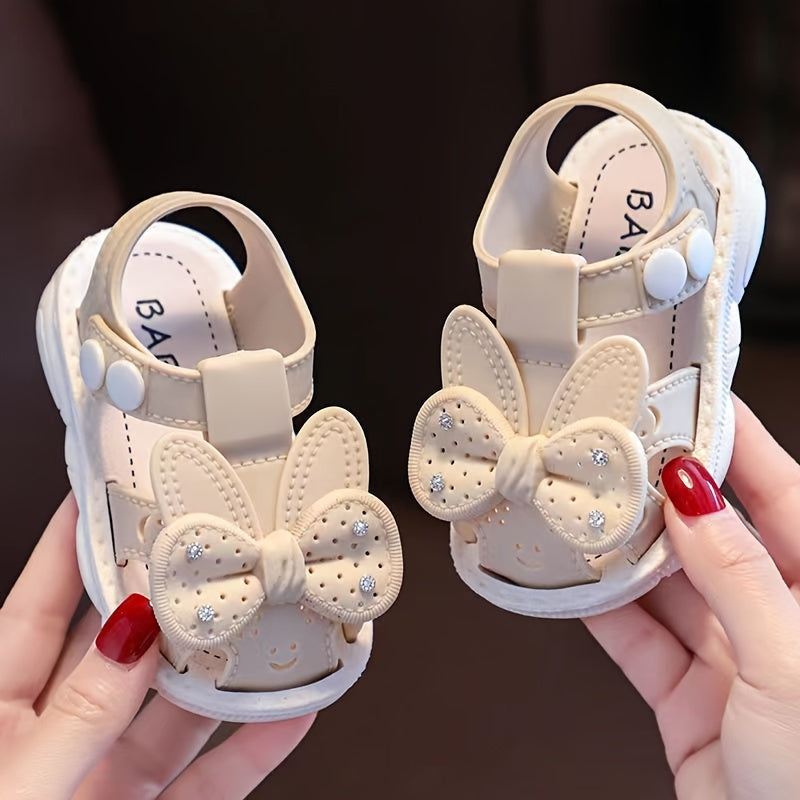 PVC low-top shoes for kids with cartoon and floral pattern, buckle closure, and soft sole.