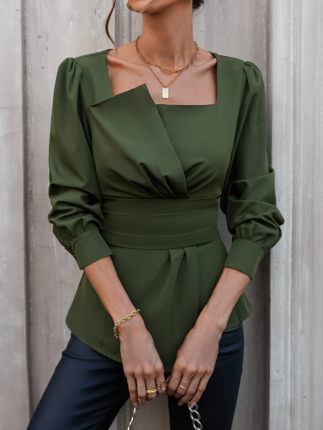 Sophisticated olive green blouse with square neckline, puffed sleeves, and asymmetric hem. Ideal for spring and summer, machine washable and dry cleanable.