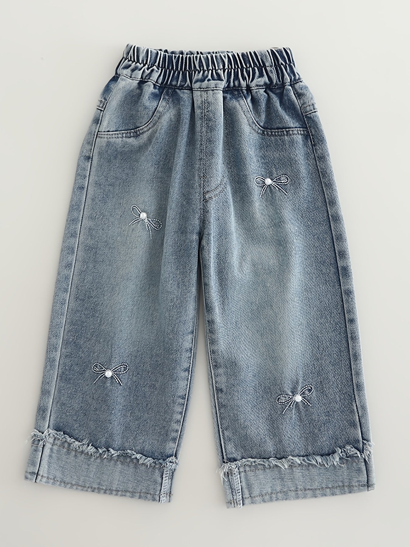 Fashionable loose-fit denim pants for girls, made of rayon blend in a solid color. Machine washable. Suitable for spring/autumn. Ideal for trendy babies. Features long pants.