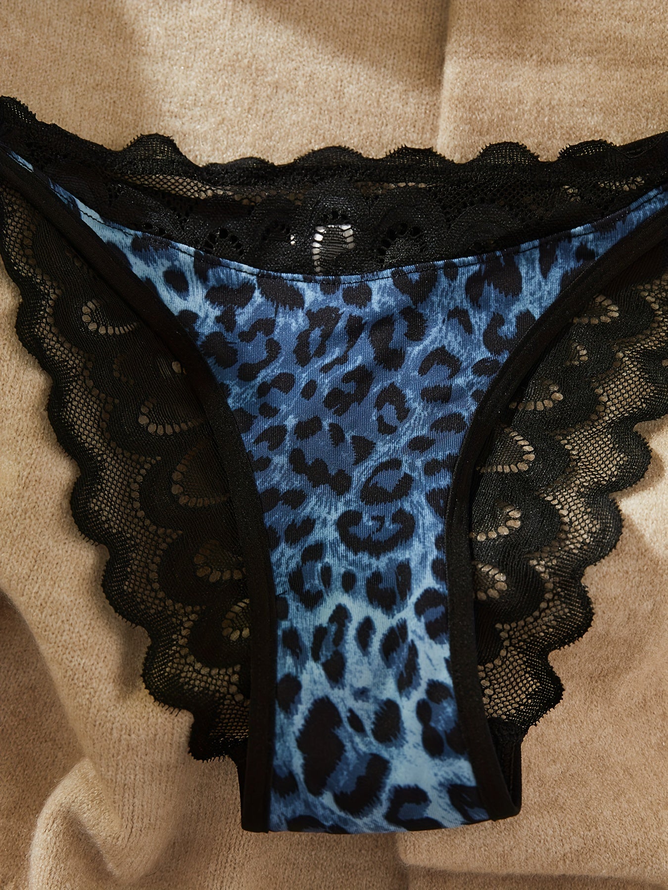 Leopard print lace lingerie set includes push-up bra and matching panties. Made of polyester/spandex blend, machine washable. Features elegant black lace detailing on both pieces.