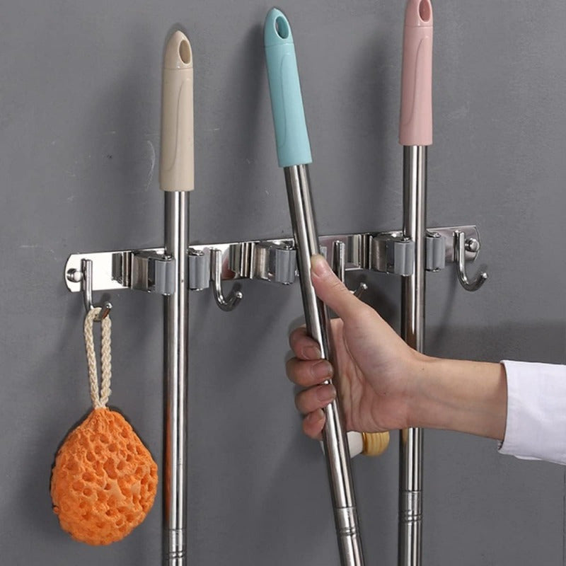 Introducing a wall-mounted mop and broom rack with 5 clips and 4 hooks, designed for easy installation without drilling. This stainless steel storage tool rack comes with perforated screws and adhesive for secure mounting. Equipped with heavy-duty hooks