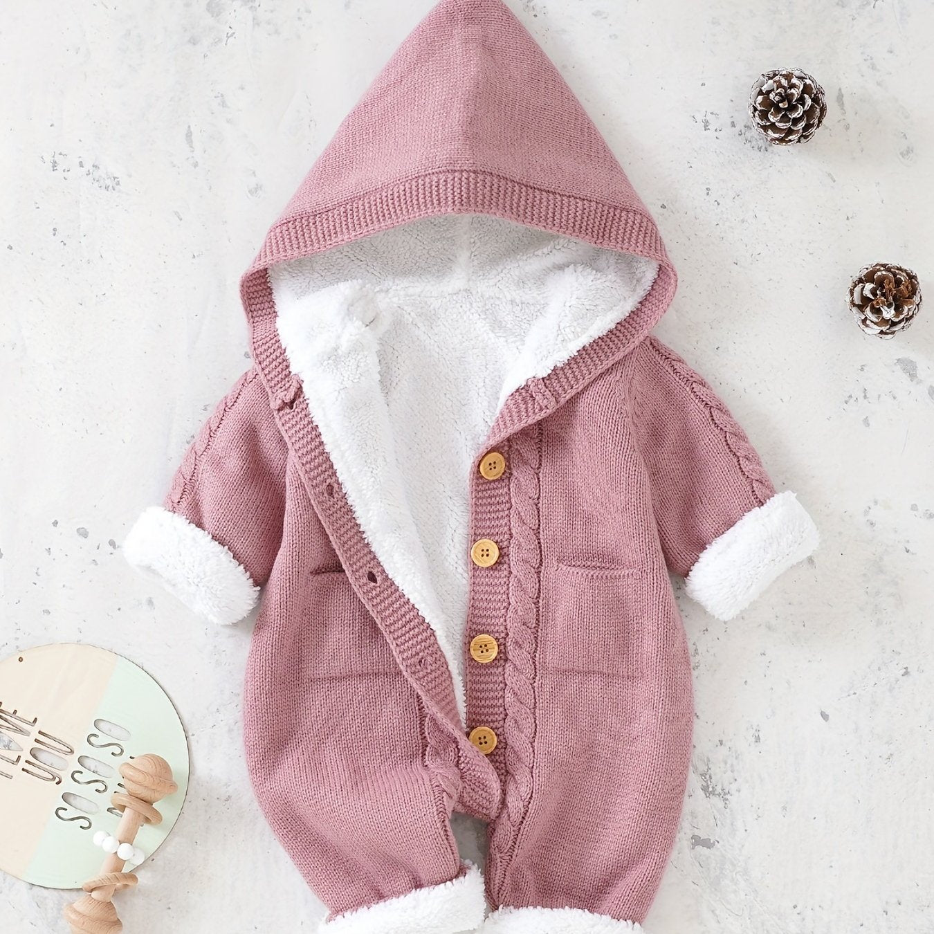 Knitted jumpsuit for newborn boys and girls with long sleeves and hooded pants.