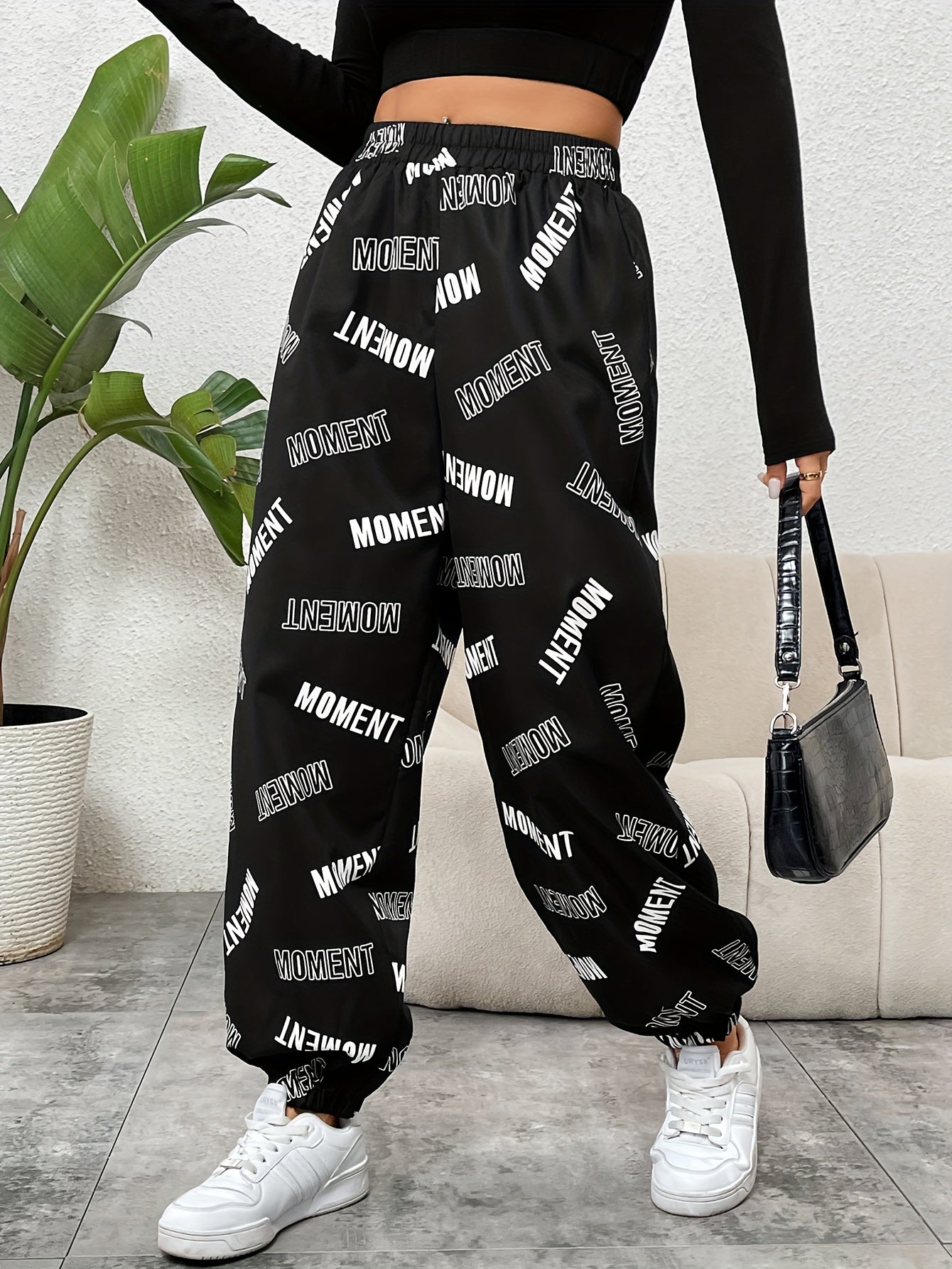 Stylish monogrammed pants for women with elastic waistband, suitable for casual or dressy occasions. Made of polyester, machine washable, and versatile in style.