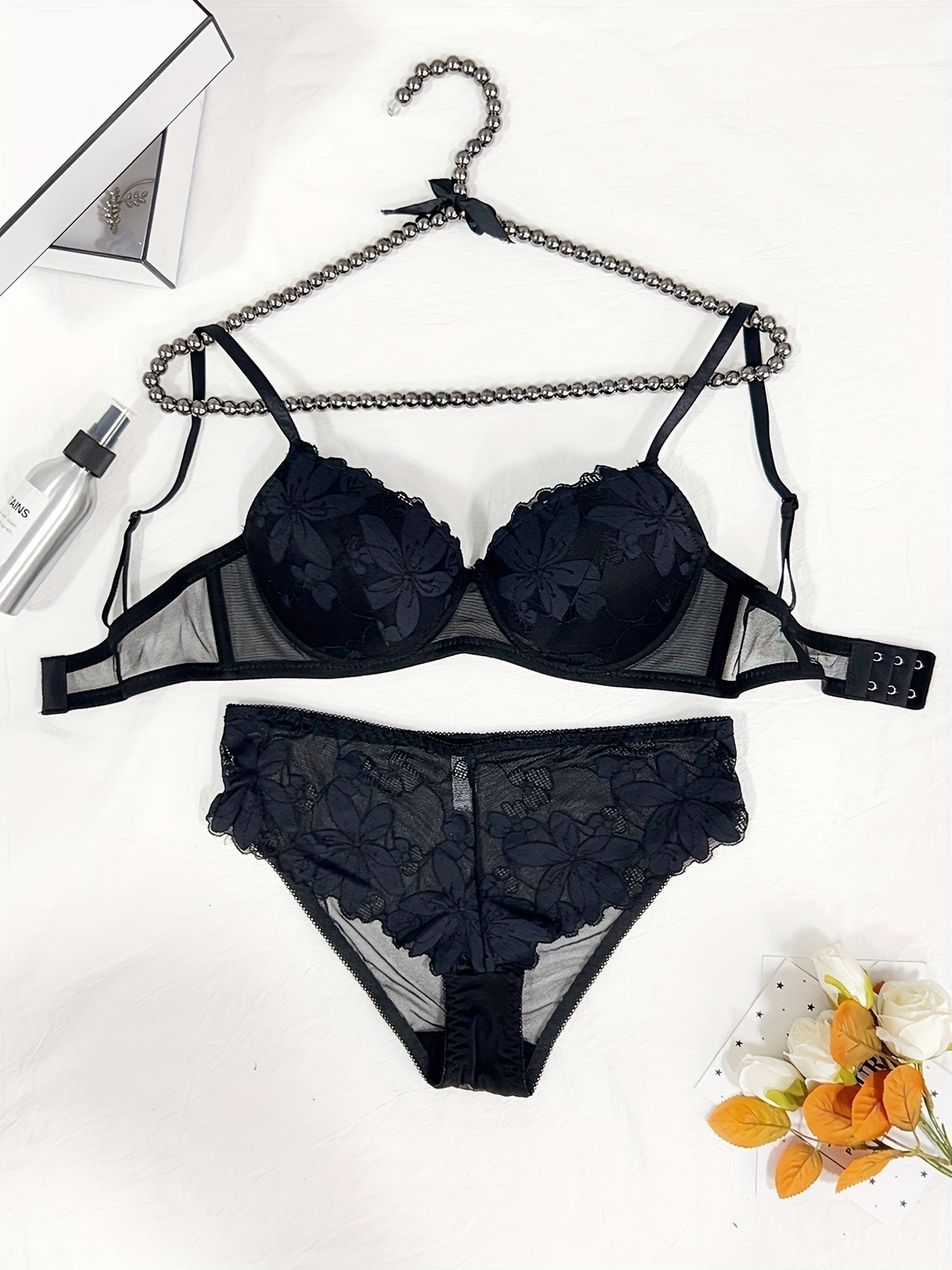 Floral embroidered lingerie set for women featuring a comfortable push-up bra, low-rise thong, mesh detail, and sexy triangle pant. Made with a nylon blend for breathability.