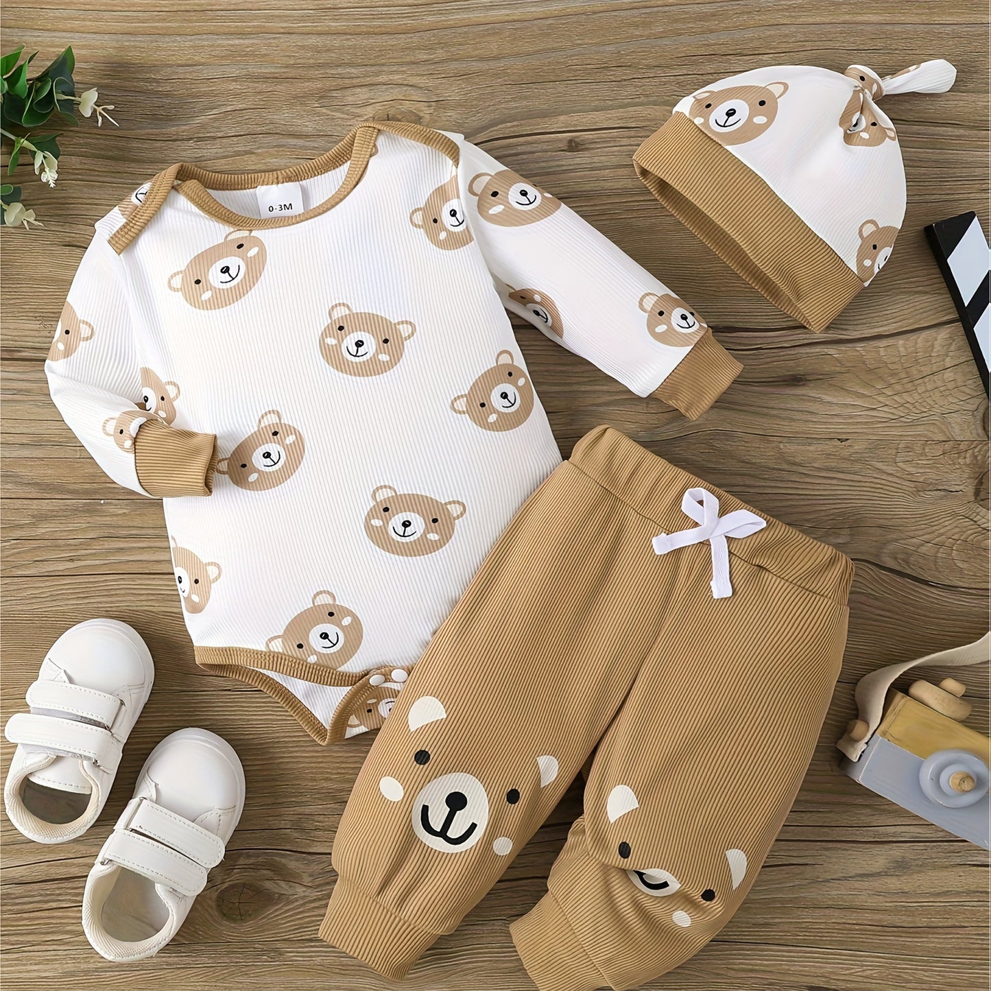 Baby's cute bear print three-piece set, includes romper, trousers, and hat. Soft and comfortable for newborns, perfect for outdoor wear.