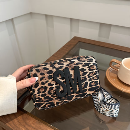 Leopard print PU crossbody bag with detachable strap in deep brown, perfect for casual or commuting outfits. Bold letter design on small shoulder bag.