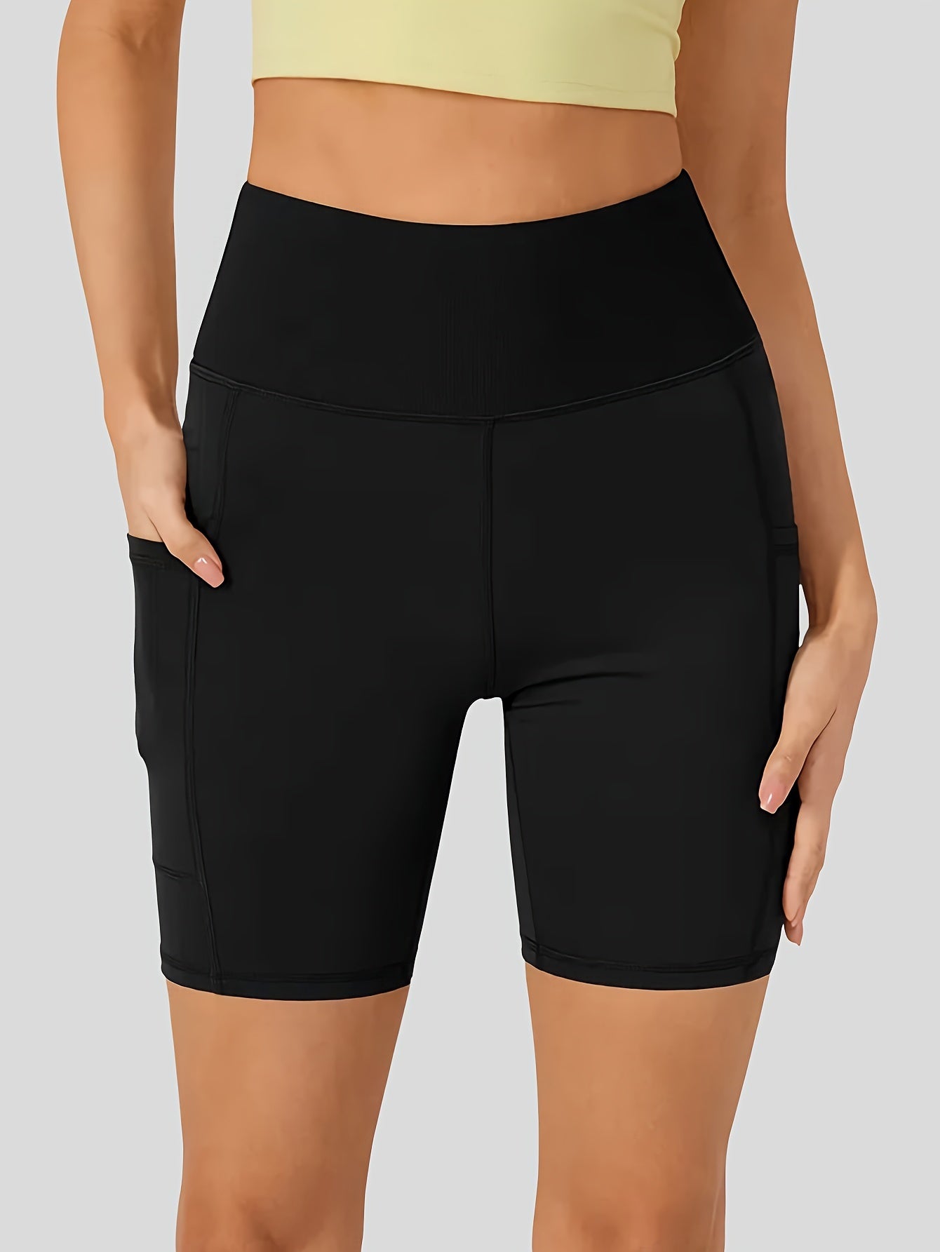 High-waist cycling shorts for women with side pockets, breathable and comfortable, perfect for fitness and outdoor activities.