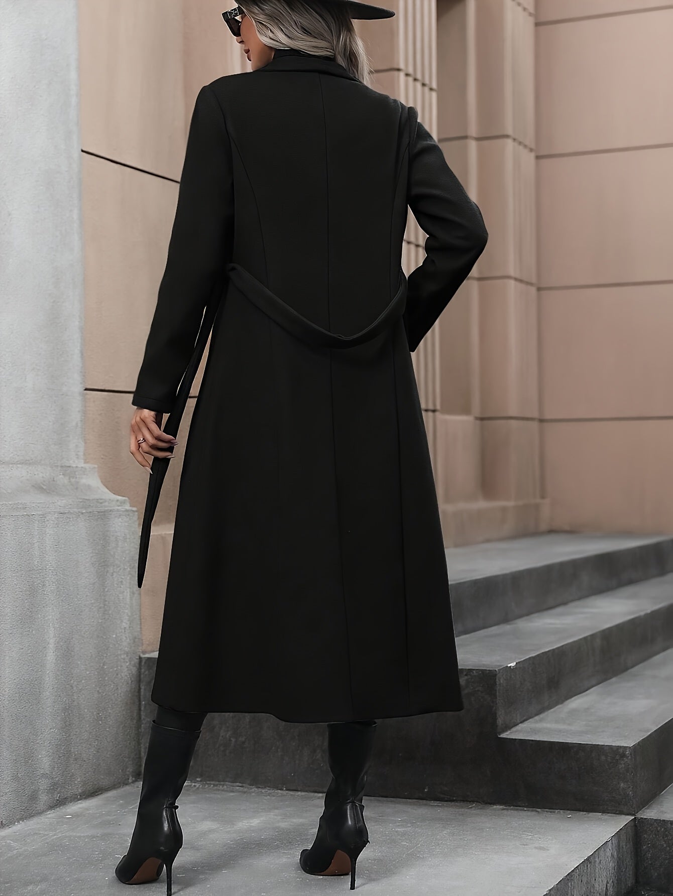 Stylish black trench coat with belt for women's fall/winter outerwear collection.