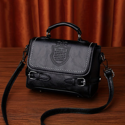 Old-fashioned handbag with embossed letter badge, stylish crossbody satchel for women.