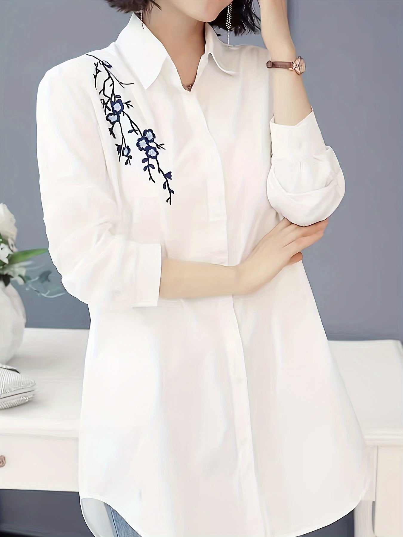 Stylish white polyester blouse with floral design, collared and machine washable for women; perfect for spring, summer, and fall.