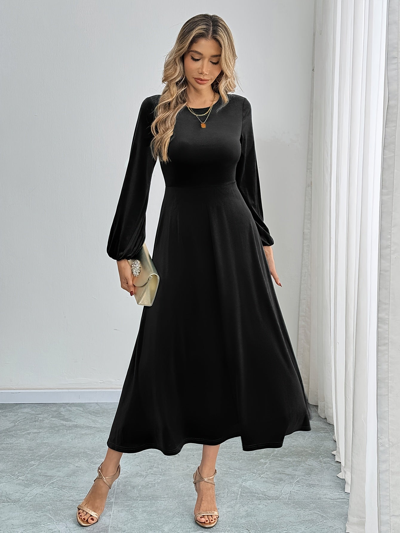 Black velvet A-line dress with flared sleeves, crew neck, and long sleeve made of polyester knit for all-season wear. Ideal for adult women's fashion as elegant attire.