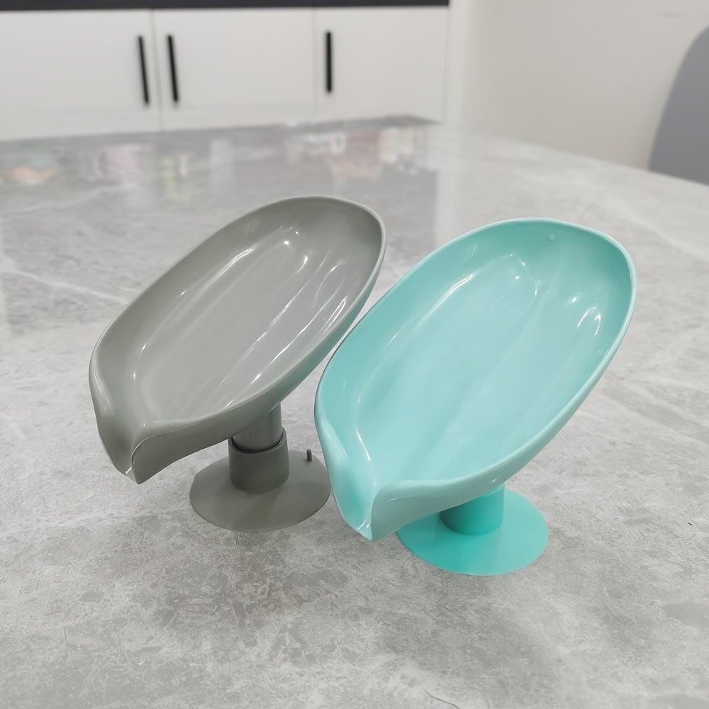 Plastic oval soap dish with suction cup design for home use.