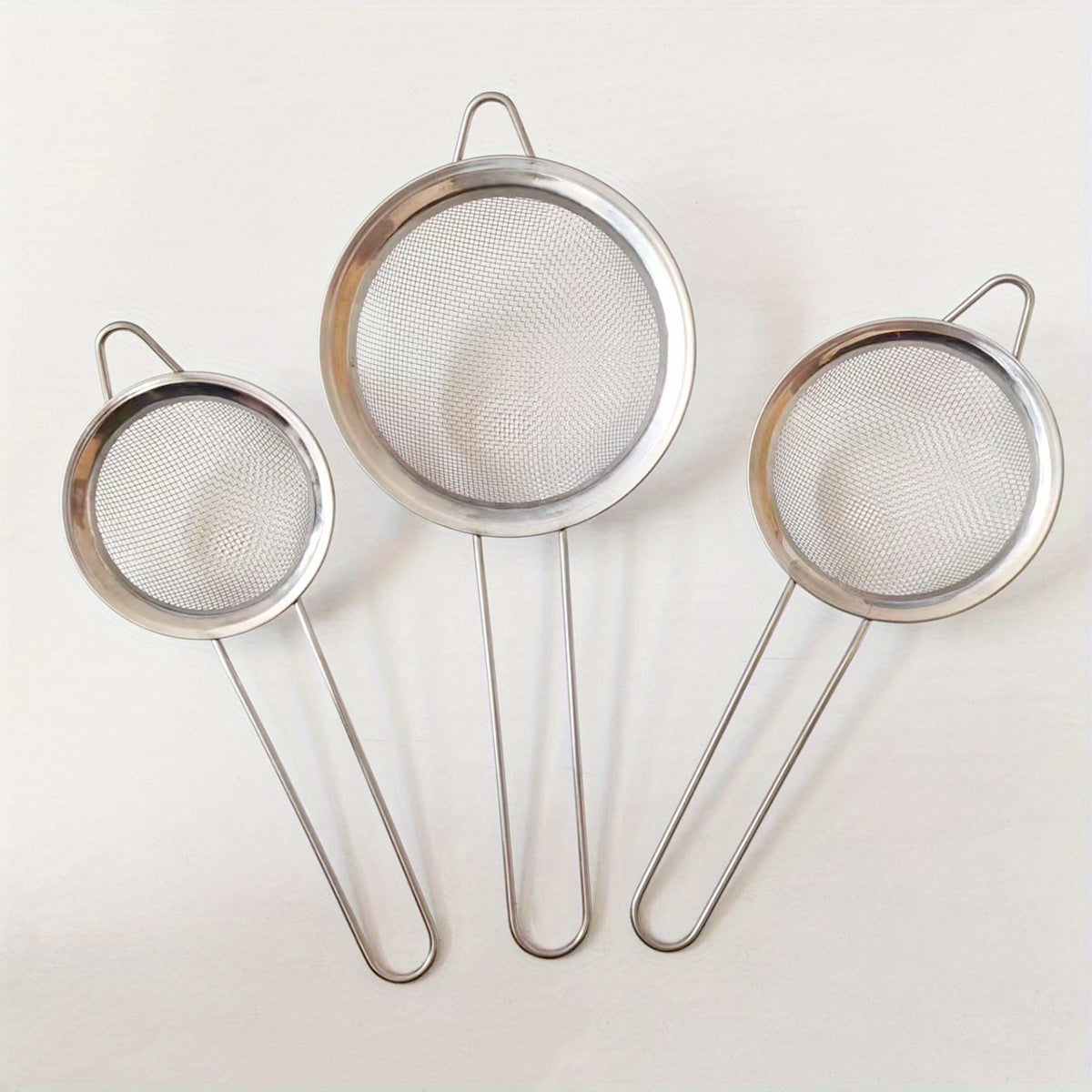 Essential Kitchen Tools: Stainless Steel Fine Mesh Strainers Set of 3 - Small, Medium, and Large Sizes with Sturdy Handle and Hook - Ideal for Juicing, Soy Milk, and More. Includes Kitchen Accessories.